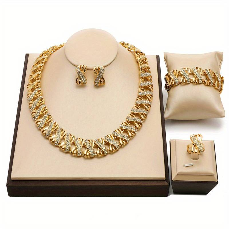 Gold plated jewellery set that features a necklace, bracelet, earrings, displayed on a jewelry stand.