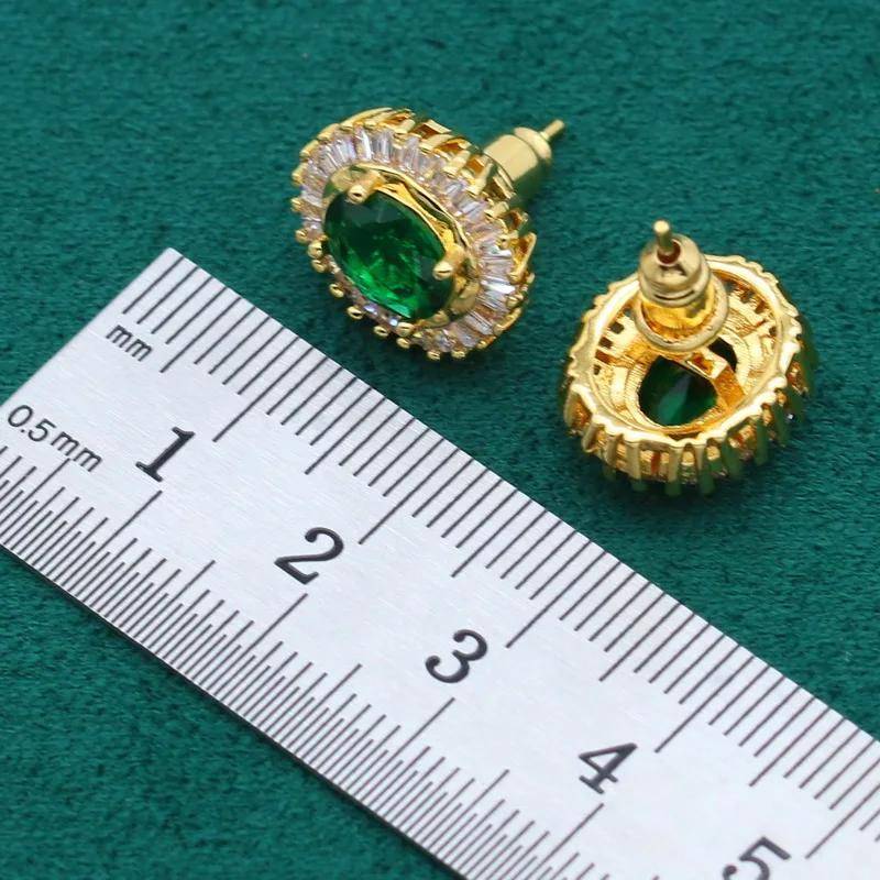 Close-up of a pair of 18K gold plated stud earrings featuring green oval gemstones and sparkling cubic zirconia accents.