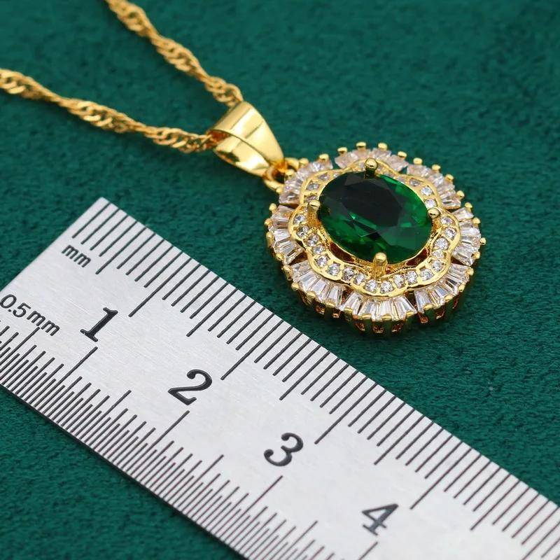 Close-up of a stunning 18K gold plated necklace with a green oval gemstone surrounded by sparkling cubic zirconia.