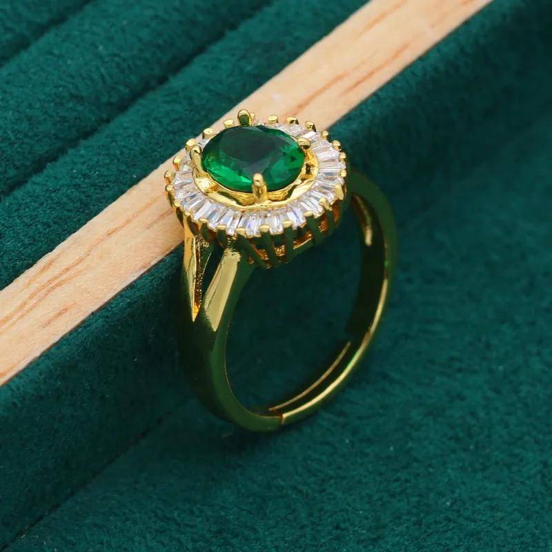 Elegant 18K gold plated ring featuring a stunning green oval gemstone surrounded by a halo of sparkling cubic zirconia.